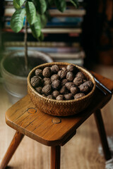 walnuts in wooden bowl on the wooden chair