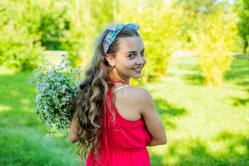 Time to have adventure. Happy girl smile with flowers on natural landscape. Outdoor recreation....
