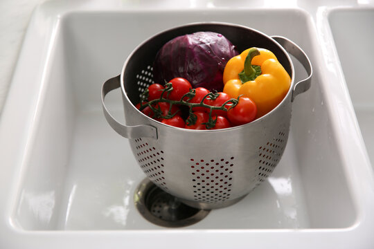 Colander Pot With Fresh Vegetables In Kitchen Sink