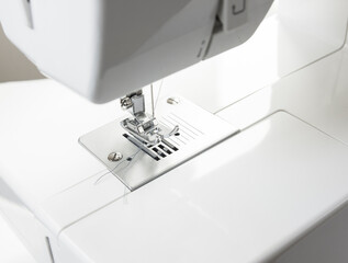 Close-up of sewing machine and sewing needle in fashion design studio