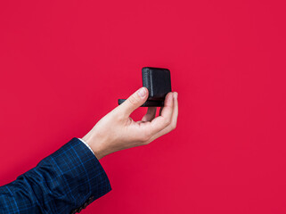 man make marriage proposal holding in hand gift box with engagement ring, love