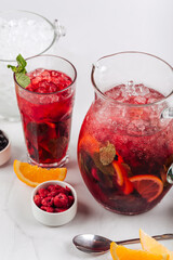 Fresh raspberry lemonade with mint and orange