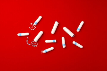 Pile of female tampons on red background