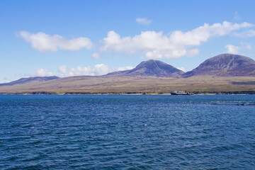 A ferry boat passing the Paps of Jura seen from Islay