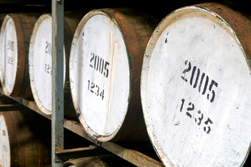 Whisky barrels in a Scottish distillery warehouse used for the maturation of whisky