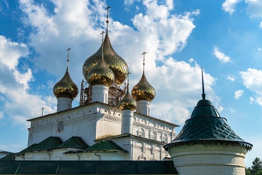 Russia, Uglich, July 2020. Domes of the cathedral and watchtower against the background of the cloudy sky.