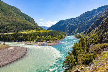 Fototapeta na wymiar The confluence of two beautiful rivers among the Altai mountains