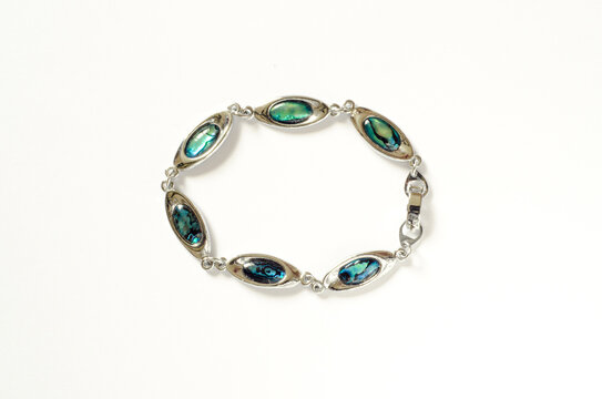 Silver bracelet with blue stones on white background