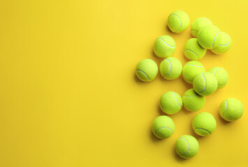 Tennis balls on yellow background, flat lay. Space for text