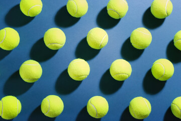Tennis balls on blue background, flat lay. Sports equipment