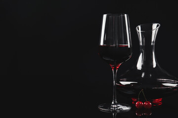 Delicious cherry wine and ripe juicy berries on black background. Space for text