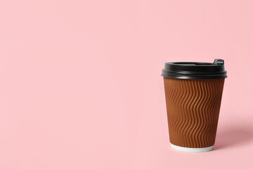 Takeaway paper coffee cup on pink background. Space for text