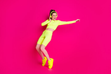 Fototapeta na wymiar Full length body size view of her she nice attractive slender sporty funky cheerful girl listening music dancing having fun rest chill isolated bright vivid shine vibrant pink fuchsia color background
