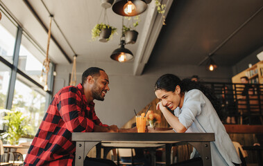 Couple in love smiling at a coffee shop