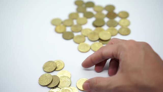 Slow motion footage hand a man counting coins on white background