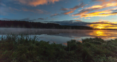 Fototapeta na wymiar Summer dawn on a pond with fog