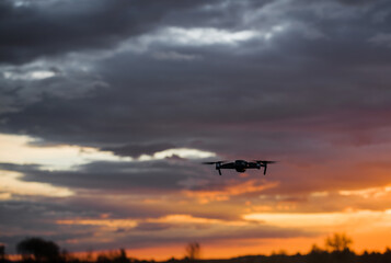 Fototapeta na wymiar drone quadcopter with digital camera at beautiful sunrise sky.