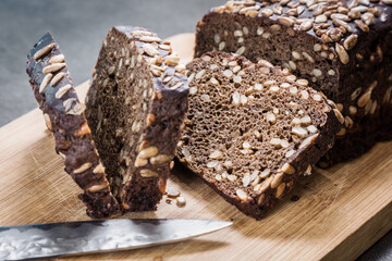 black whole grain bread with seeds and cereals cut into pieces