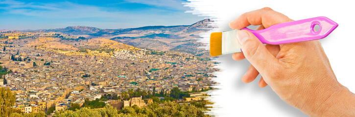 Fes aerial panoramic landscape with the medieval medina, the mountain on background and olive grove in the foreground - concept image with hand and brush