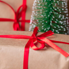 Christmas gift boxes wrapped in recycled paper with red ribbon bow