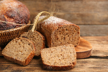 Tasty freshly baked bread on wooden table