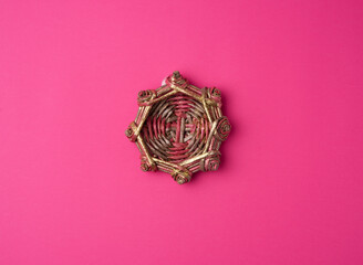 wicker decorative nest on a pink background