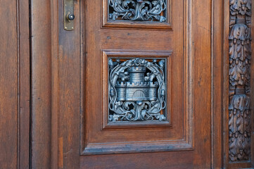 Metal castle symbol on a wooden vintage door brown