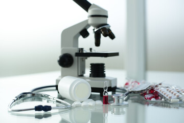 Stethoscope ampoule pill microscope on glass table