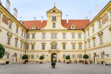 Tourists walk through garden from Valtice castle, UNESCO (Czech Republic)