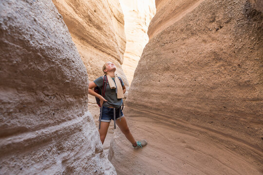 12 year old girl hiking in beautiful slot canyon, Kasha Katuwe, Tent Rocks, New Mexico.