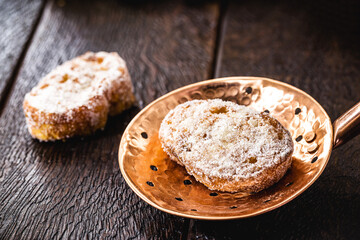 slice of fried bread with cinnamon and sugar in old copper skimmer. Dessert called 