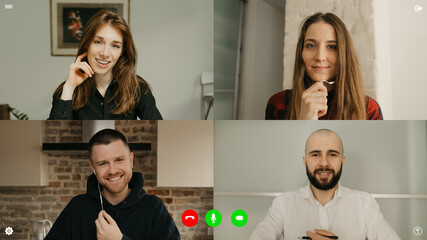A desktop computer screen view of the telecommunications application during a video chat on which colleagues are happy to see each other alive. A multi-ethnic business team in an online meeting