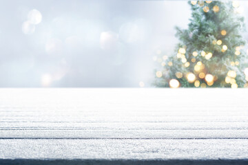 Empty wooden table with christmas tree in frosty winter. Horizontal background with bokeh and short...