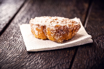 fried or baked bread with cinnamon and sugar in an antique copper skimmer. Called rabanada in brazil, portuguese gold slice in portugal and spanish torrijas in spain