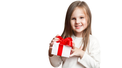 Happy laughing little girl, preschooler holding birthday present, gift box with red bow. excited and surprised. a forced, insincere smile. bad gift, disappointment. on white background.