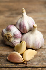 Fresh organic garlic on wooden table, closeup