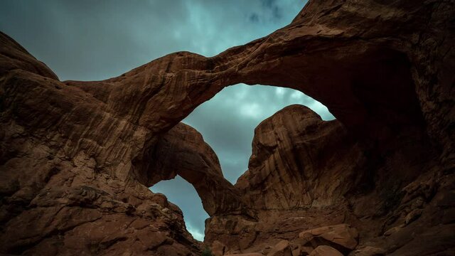 Time Lapse of Natural Double Arch adn Dramatic Dynamic Cloudy Sky Above Natural Landmark of Arches National Park, Utah USA