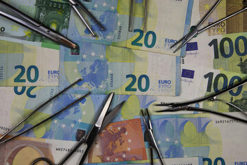 View on surgical instruments on euro paper money currency banknotes - financial market regulation concept