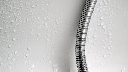 Shower water pearls and water drops with bathtub Background.