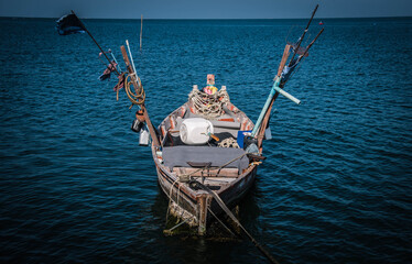 A traditional fishing boat stops at Hat Won Pier, Bang Saen District, Chonburi Province