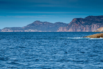 Fototapeta na wymiar View of the coast of the Freycinet Peninsula, Tasmania from a boat on a sunny day
