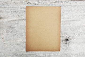 Old kraft brown vintage paper texture on grey wooden table suface 

