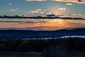The setting sun lights up Penobscot Bay, Walker Pond, and the autumn landscape west of Caterpillar Hill, Sedgewick, Maine