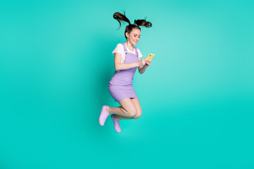 Full length body size side profile photo of female blogger texting on smartphone using app isolated on bright teal color background