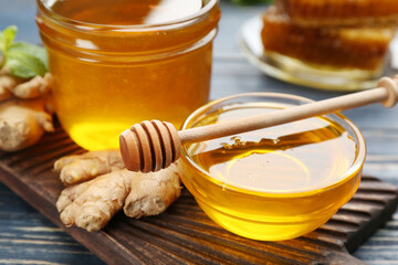 Honey and ginger on blue wooden table, closeup. Natural cold remedies