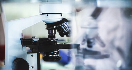 Close up on microscope and laboratory glassware. Modern laboratory interior