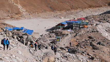 Group of trekkers arriving in remote village Gorakshep (altitude 5,164 m), the last stop before...