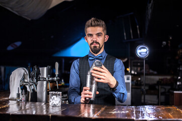 Professional tapster is pouring a drink at the nightclub