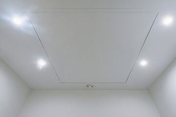 White office ceiling with lighting and ventilation equipment.