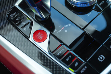 Car engine push start stop button ignition remote starter. Car dashboard:   red engine start stop...